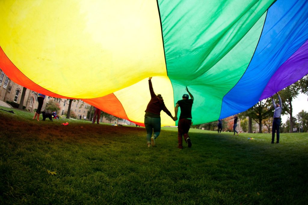 Friends under a rainbow flag