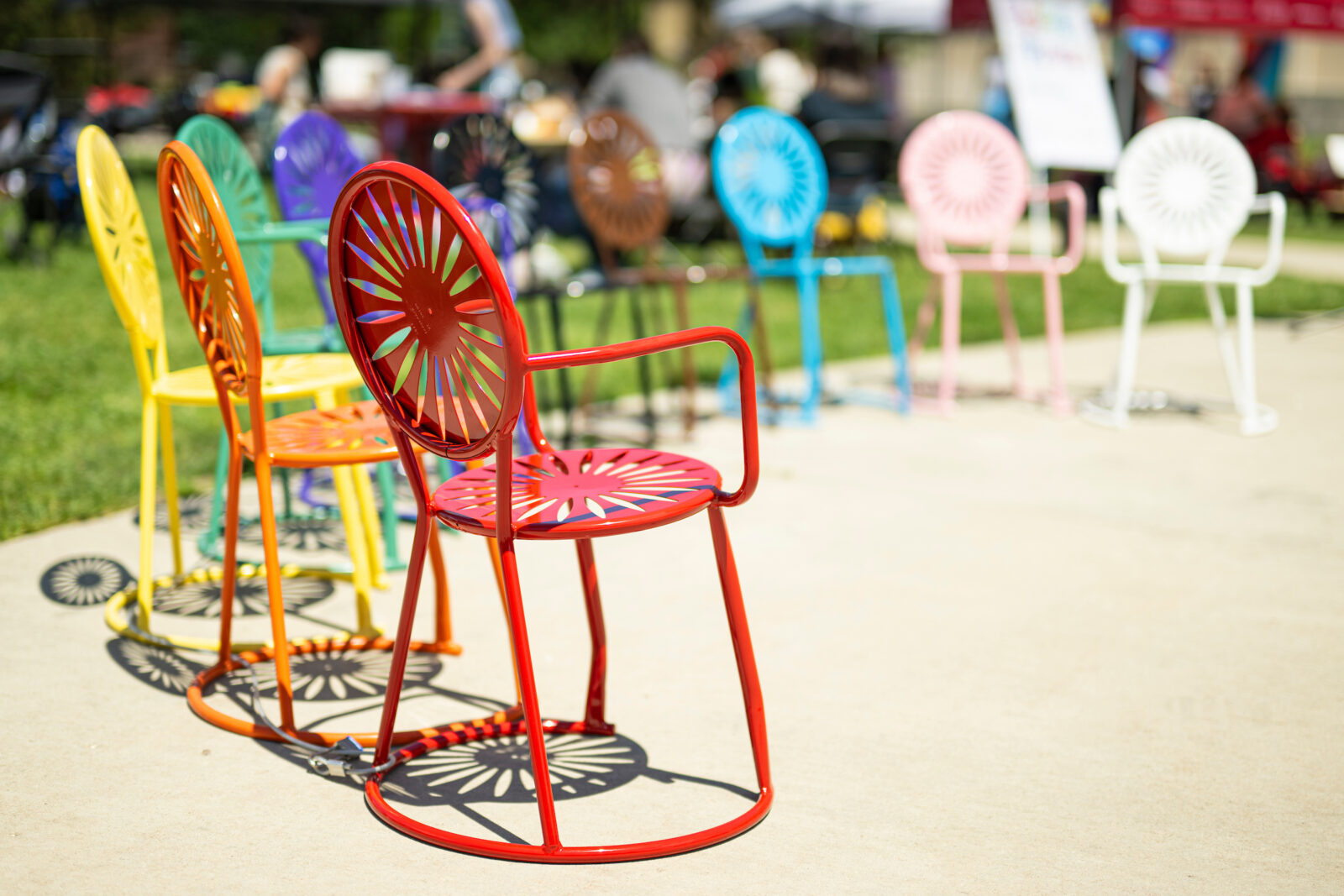 Terrace chairs arranged in a rainbow.